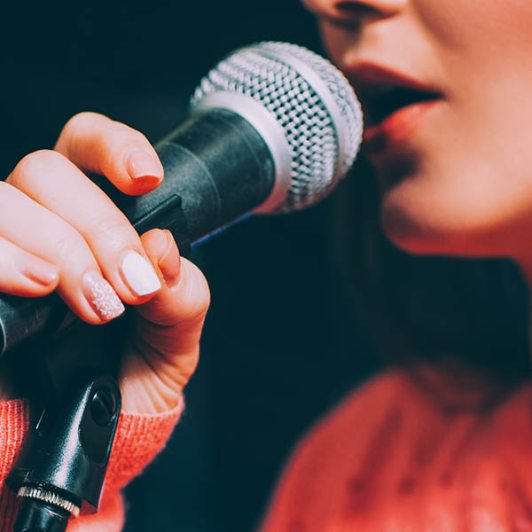 https://oakvillevocalartsfestival.ca/wp-content/uploads/young-woman-singing-microphone-product.jpg